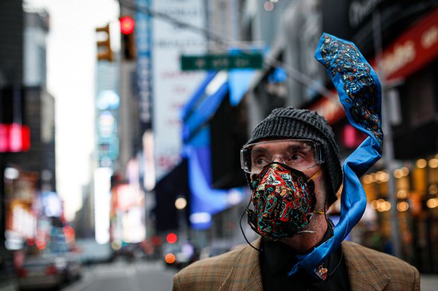 Performance artist Lynx Alexander walks through Times Square wearing a customized breathing mask in response to the spread of COVID-19, in New York, N.Y. On March 11, 2020